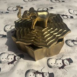 Decorative elephant trinket box with gold finish. Great for jewelry, keepsakes, or shelf décor. Excellent condition.