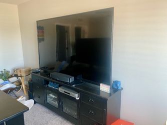 80 inch Sharp TV and tv stand table shown