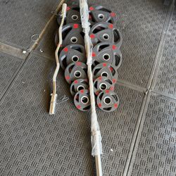 Rubber Olympic weights 250lbs total plus 7ft 45lbs bar plus curl bar