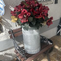 Artificial flower arrangement in a tin vase