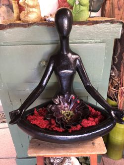 Beautiful black female yoga succulent arrangement. Plants will vary