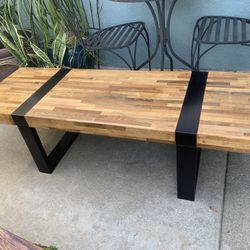 Modern Crate & Barrel coffee table with reclaimed wood top and metal base.