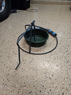 Free 24 In Metal Tree Stand And Water Bucket.