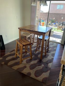 Bar style dinning table with four stools