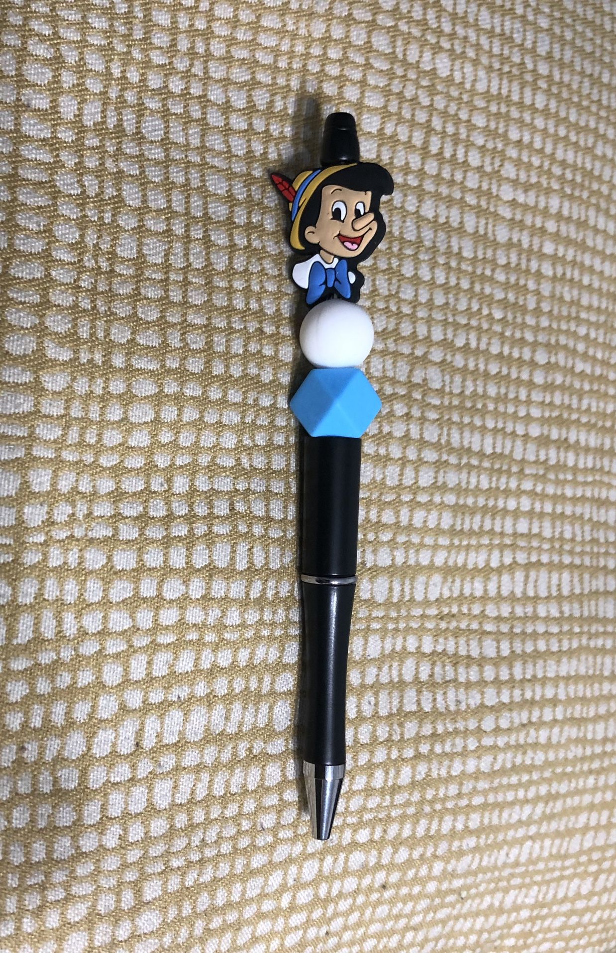 Pinocchio beads pen. Color black. Size 6”LX 1” W