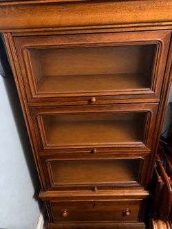 Stanley Furniture solid wood glass-front cabinet from a matching collection. It features three spacious display/storage compartments with glass doors