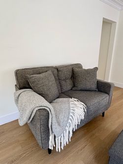 Gray upholstered small sofa