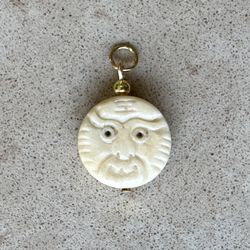 😳 Funky, off white beaded face pendant with gold tone bead