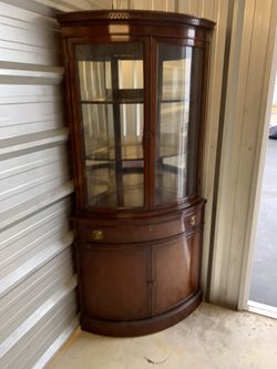 Antique curved front corner cabinet