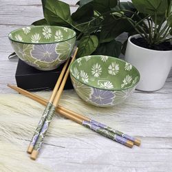 Medici Sushi Serving Set, which includes two green porcelain bowls with floral patterns and two pairs of chopsticks. The bowls are primarily light gre