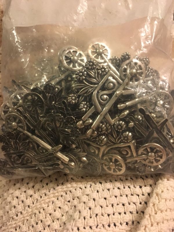 Metal wheelbarrow with flowers , arts and craft , pins , put on the fridge with a magnet . $2.50each . Great for Mother’s Day