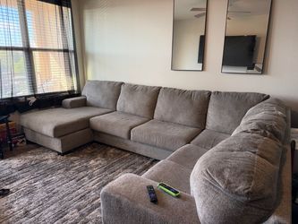 Dark grey L-shaped couch with a Lounge