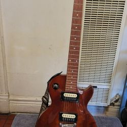 EPIPHONE LES PAUL STUDIO LT  ELECTRIC GUITAR WITH DUAL IPHONE ZEBRA COIL HUMBUCKER IN WALNUT COLOR. 