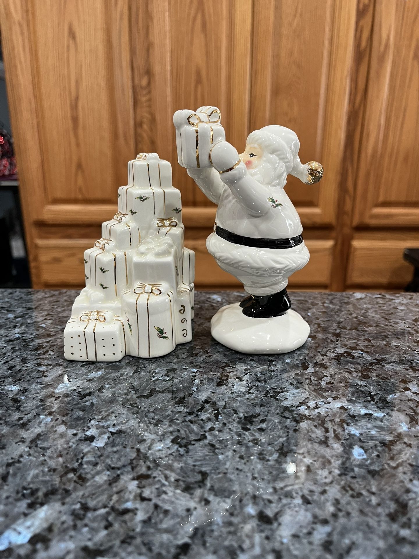 Ceramic Santa Delivering Presents White and Gold Pair of Salt and Pepper Shakers. Size Santa is 5 1/2 inches tall. Preowned never used.