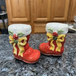 Ceramic Christmas Santa Claus Boots Pair of Salt and Pepper  with Yellow Bow And Holly.  Preowned.  Has been on display in a cabinet with a very large