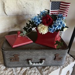 Vintage Suitcase And Patriotic Floral Arrangement In A Red Canister 