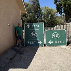 Two large Highway 90 Retired Signs