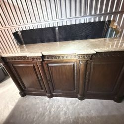 Traditional buffet cabinet featuring a marble top 