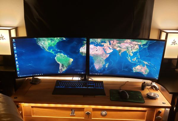 Dual 27" curved Samsung monitors. One is Samsung's Qled gaming monitor