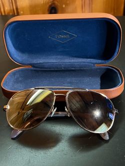 Fossil women's aviator sunglasses with metal frames and protective case.