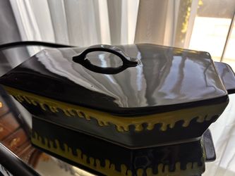 Rae Dunn "Slime Drip" coffin-shaped baking dish with a matching lid.