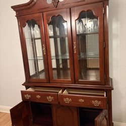 Lighted wood and glass curio cabinet