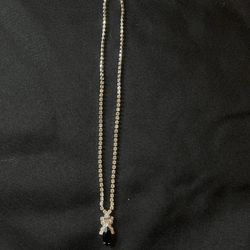 shiny silver necklace with black pendant 