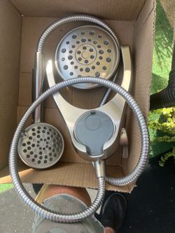stainless steel showerhead with attached hose and sprayer