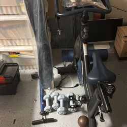 MYX fitness bike, yoga mats, foam roller, and weights