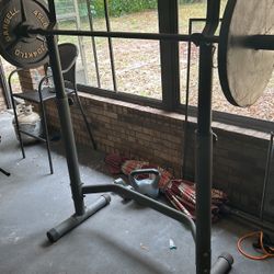Squat rack, Bench press with preacher curls, and leg extension machine with hamstrings curls 
