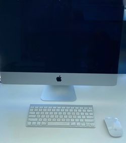 Mac desktop with mouse and 2 keyboards