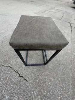 Gray Faux Leather Ottoman with Metal Base