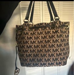 Tan in black Michael Kors bag