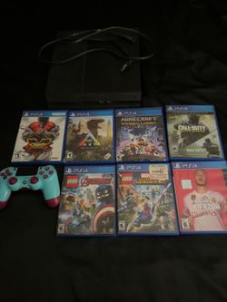 PlayStation 4 with games, controller, and charging station