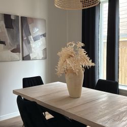 Dinning table and black tufted chairs.