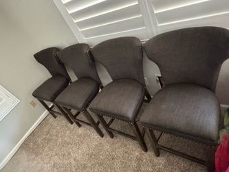 4 cushioned gray barstool chairs