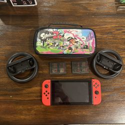 Nintendo Switch With 8 Games, Splatoon 2 Holder/Bag, and Nintendo Switch Mario Cart Controller Wheels