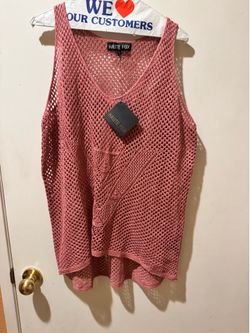 Sleeveless crochet in a rose pink hue. Lightweight, breathable knit with a relaxed fit. Layer over camis or swimwear for a stylish, casual look. Rose 