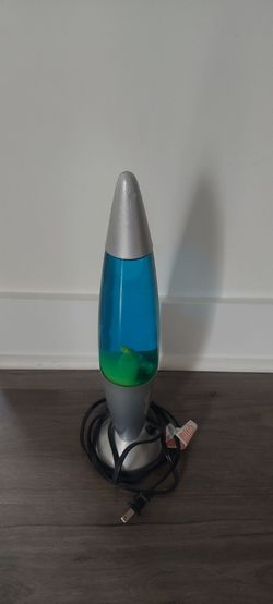 Colorful lava lamp has blue liquid and green wax. Silver base and top.