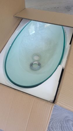 Two Clear Vessel Sinks With Black Faucets