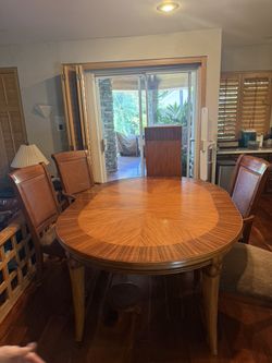 Tommy Bahama Table with 2 leafs  and 6 chairs  good condation