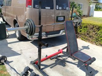 Weight lifting bench and alot of accessories