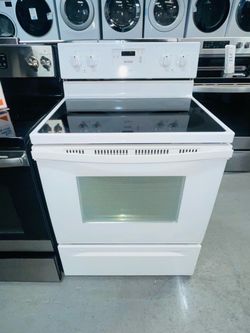 White Whirlpool electric stove; comes with a 60-day warranty (on the receipt).