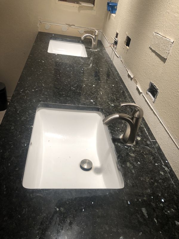 Beautiful black granite bathroom countertop with sinks and