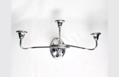 with Four new silver wall sconces that hold three candles each.