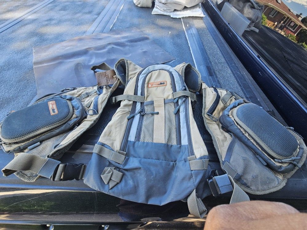 Vest for your fishing gear with many storage bags in front and back as new.