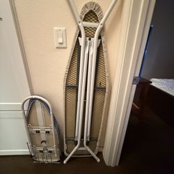 2 ironing boards and an iron