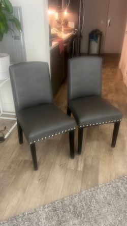 2 matching grey leathereet chairs