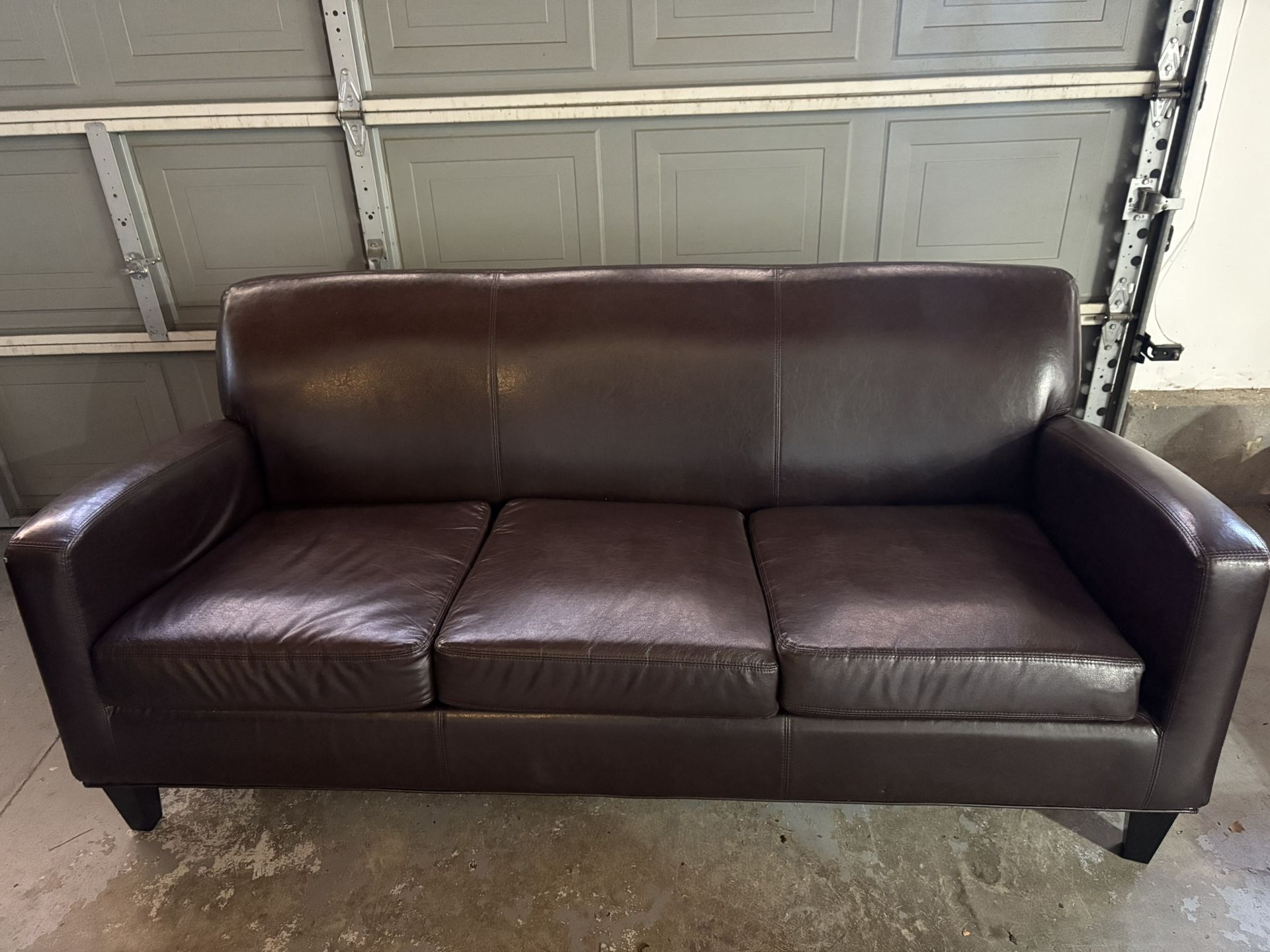 Brown faux leather couch and chair