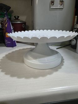 white, scalloped-edge metal cake stand